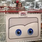 General Sherman A Cortez basket with a cartoon face featuring blue eyes, with a person looking over the side in a warehouse setting.