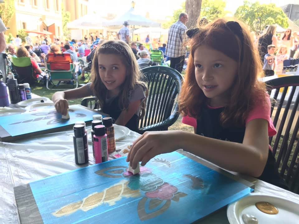 Girls Paint Boards at Outdoor Festival