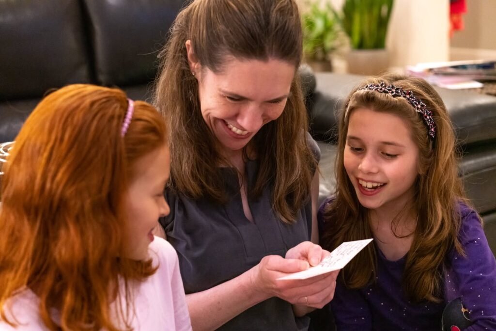 Three individuals enjoying a shared activity with a piece of paper.