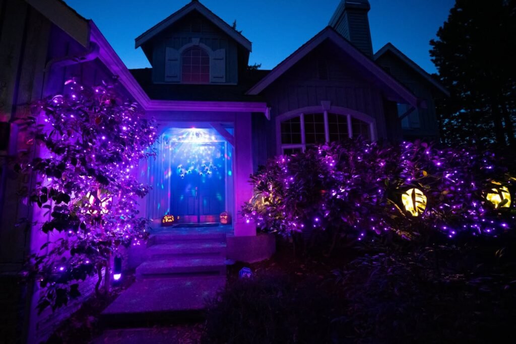 Charmingly lit house at dusk with vibrant purple and blue holiday lights. A cozy and inviting festive scene.