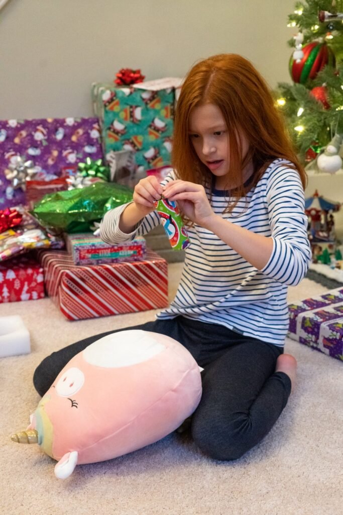 Opening Christmas gifts near the tree