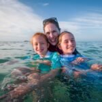 Belize Day 3 A family enjoying a day in the ocean, captured on a beautiful sunny day.