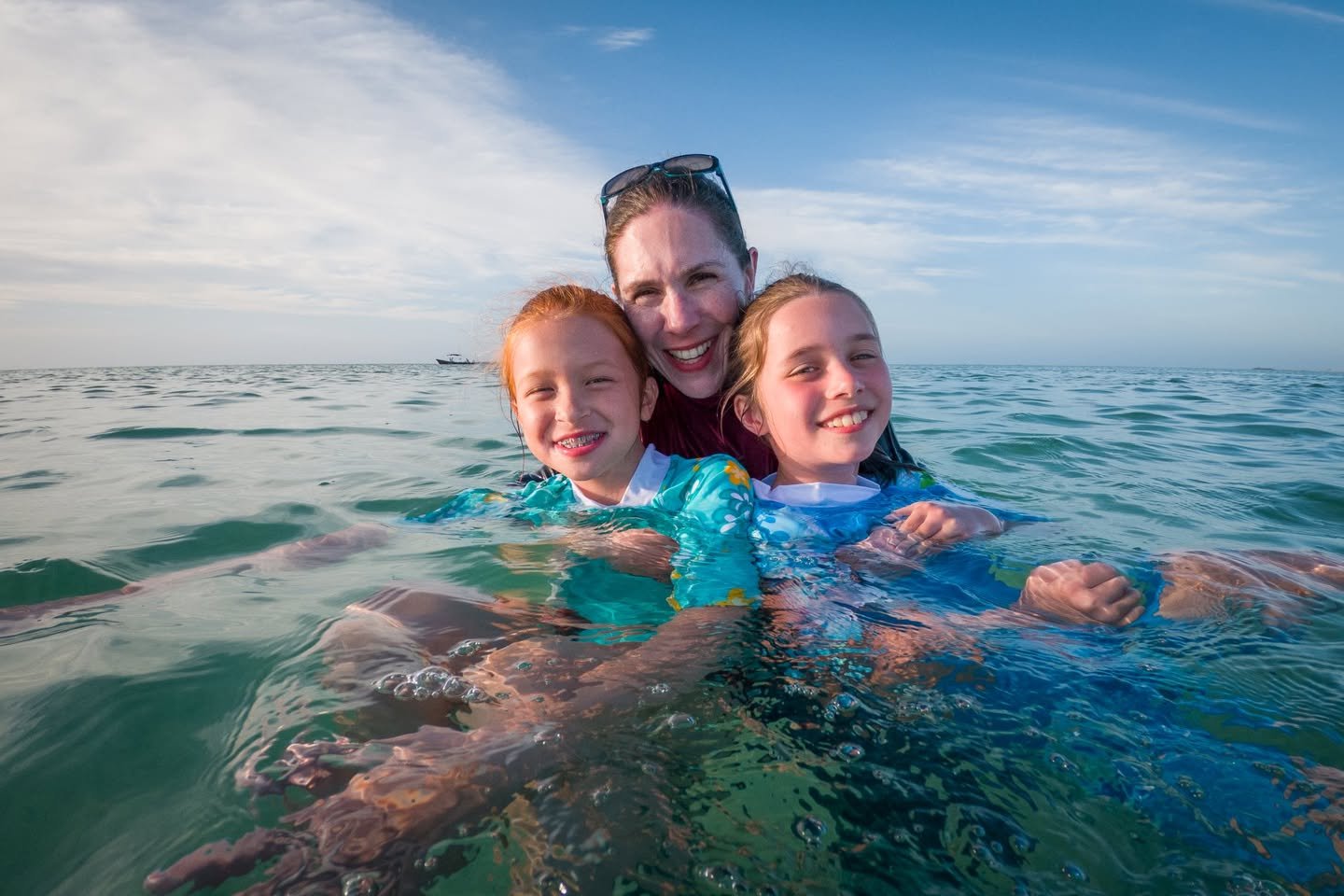 Belize Day 4 A family enjoying a day in the ocean, captured on a beautiful sunny day.