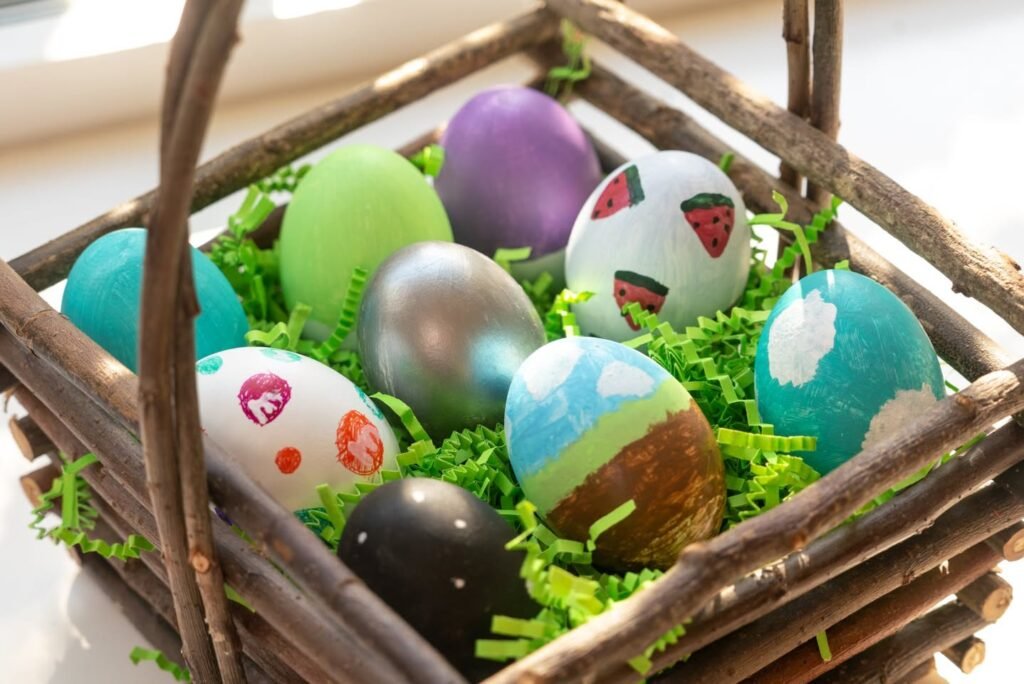 Decorated Easter eggs filled with grass in a handcrafted wooden twig basket with various patterns and vibrant colors.
