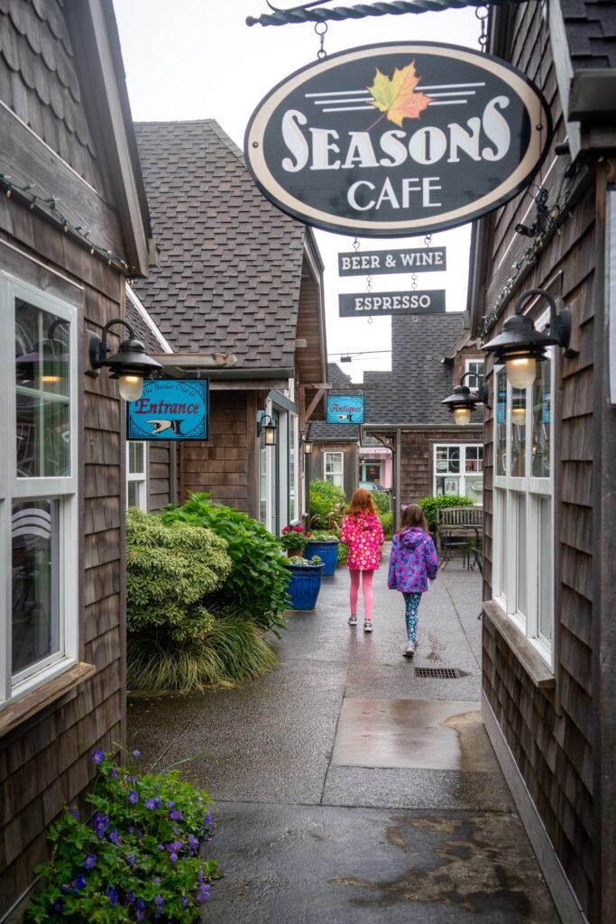 A charming alleyway leading to Seasons Cafe in the Pacific Northwest offers beer, wine, and espresso.