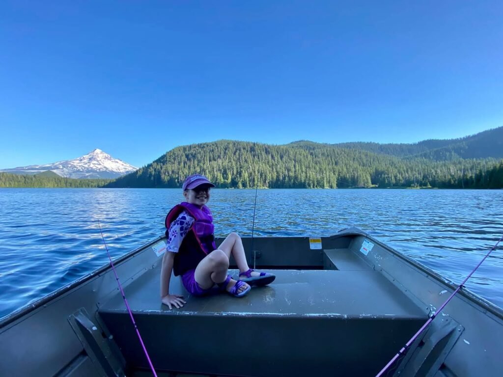 A relaxed moment on the water with a stunning view of a snow-capped mountain in the distance. The scene captures the peace and calm of a day spent fishing in the Pacific Northwest.