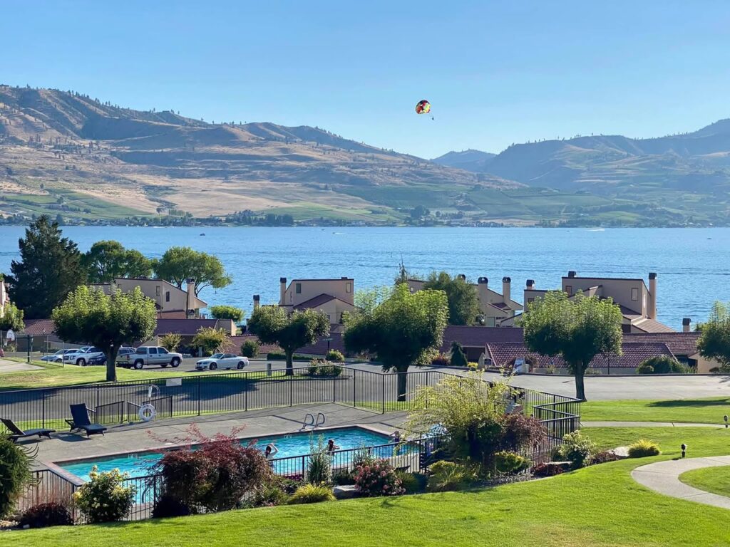 A scenic view of a beautiful pool area with a soaring bird above.