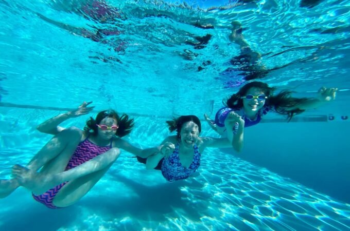 A joyful underwater photo from our family vacation, capturing the vibrant blue of a crystal clear pool.