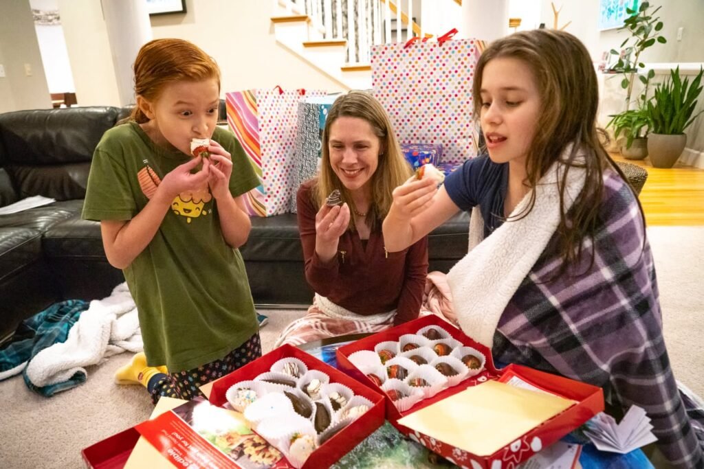 A cheerful family gathered around a table full of homemade desserts. Wrap up a cozy blanket and enjoy the treats together.