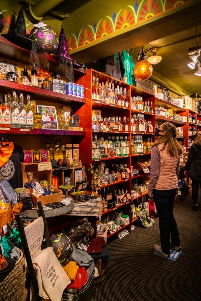 A person browsing colorful shelves in a cozy, themed retail space.