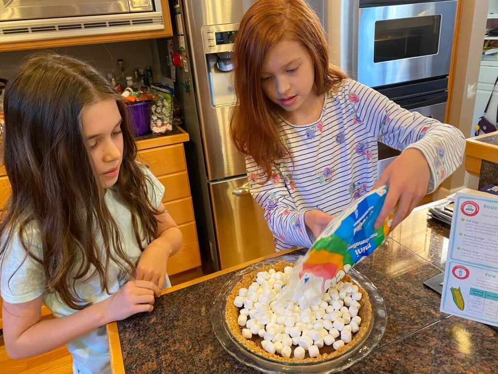 Making marshmallow pie in the kitchen