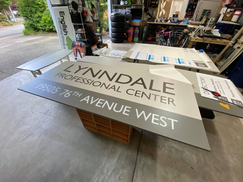 A sign for the Lynndale Professional Center at 19935 76th Avenue West is displayed on a wooden crate.