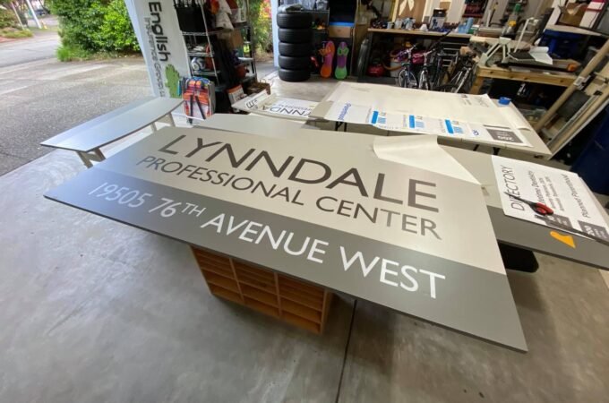 A sign for the Lynndale Professional Center at 19935 76th Avenue West is displayed on a wooden crate.