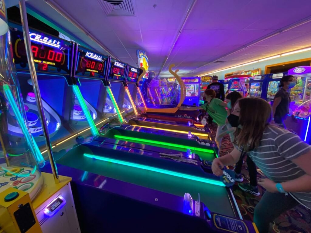 A unique immersive arcade experience with neon green tracks and glowing light displays.