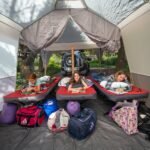 The back patio attached to our camping trailer is a good a place to work, watch rain, and shelter campfires If needed. "", "background": {"title": "Comfortable setup in our pop up rear patio of a trailer" }}