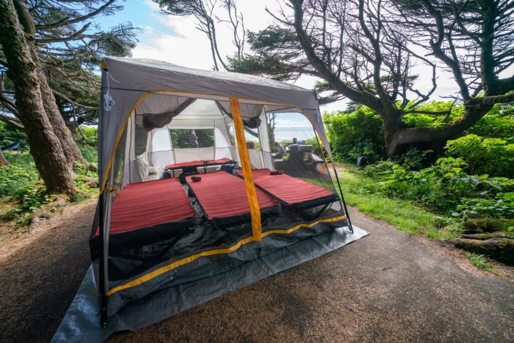 A spacious RV patio with red cushions set up in a rugged outdoor environment.