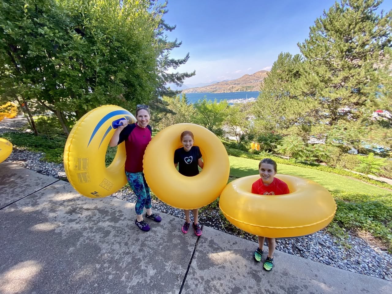 Slidewaters Family enjoying summer fun with inflatable yellow rings at Lake Coeur d'Alene.
