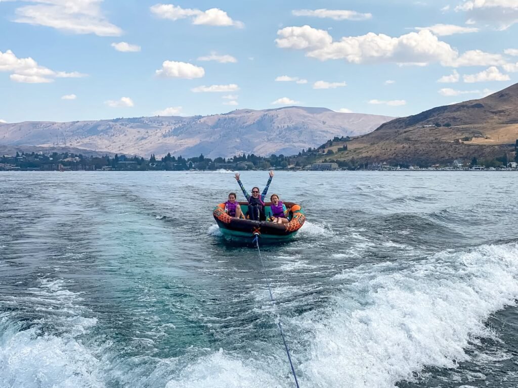 A group tubing on the Columbia River with mountains in the background.