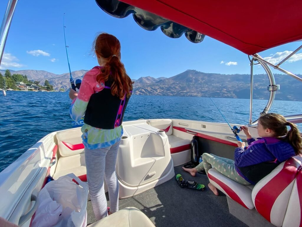 A family enjoying a fishing trip on a calm lake.