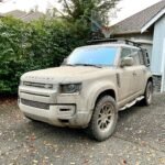 Drogon A mud-covered Land Rover Defender parked in a driveway. The vehicle shows signs of recent off-road adventure in the Pacific Northwest.