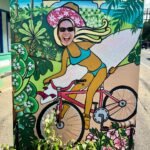 Kahuku Food Trucks A colorful face board depicts a cyclist surfing through a tropical landscape.