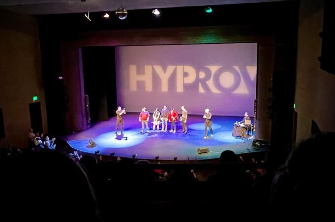 View of a HYPROX live performance on stage. The scene is captured from the audience perspective.
