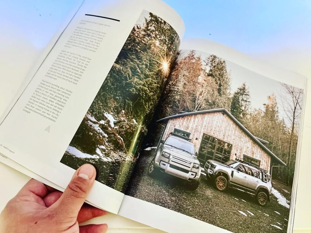 Open photography book displaying a garage with off-road vehicles and a forest landscape page.