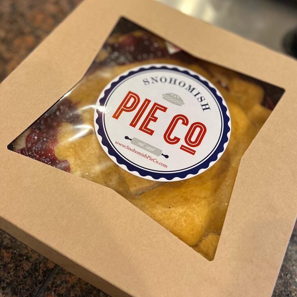 Two snazzy packages of berry pie from Snohomish Pie Co. on a kitchen counter.