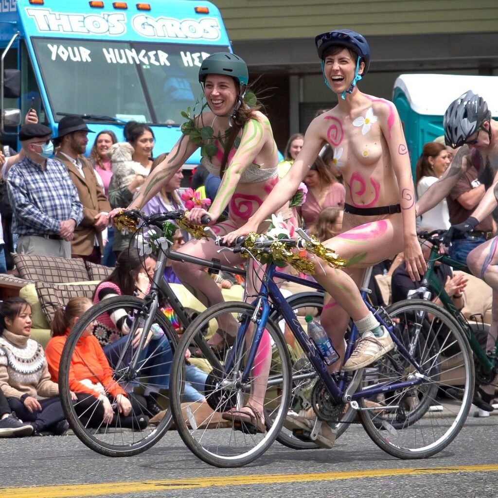 Participants in the Naked Bike Ride pedaling through the streets.