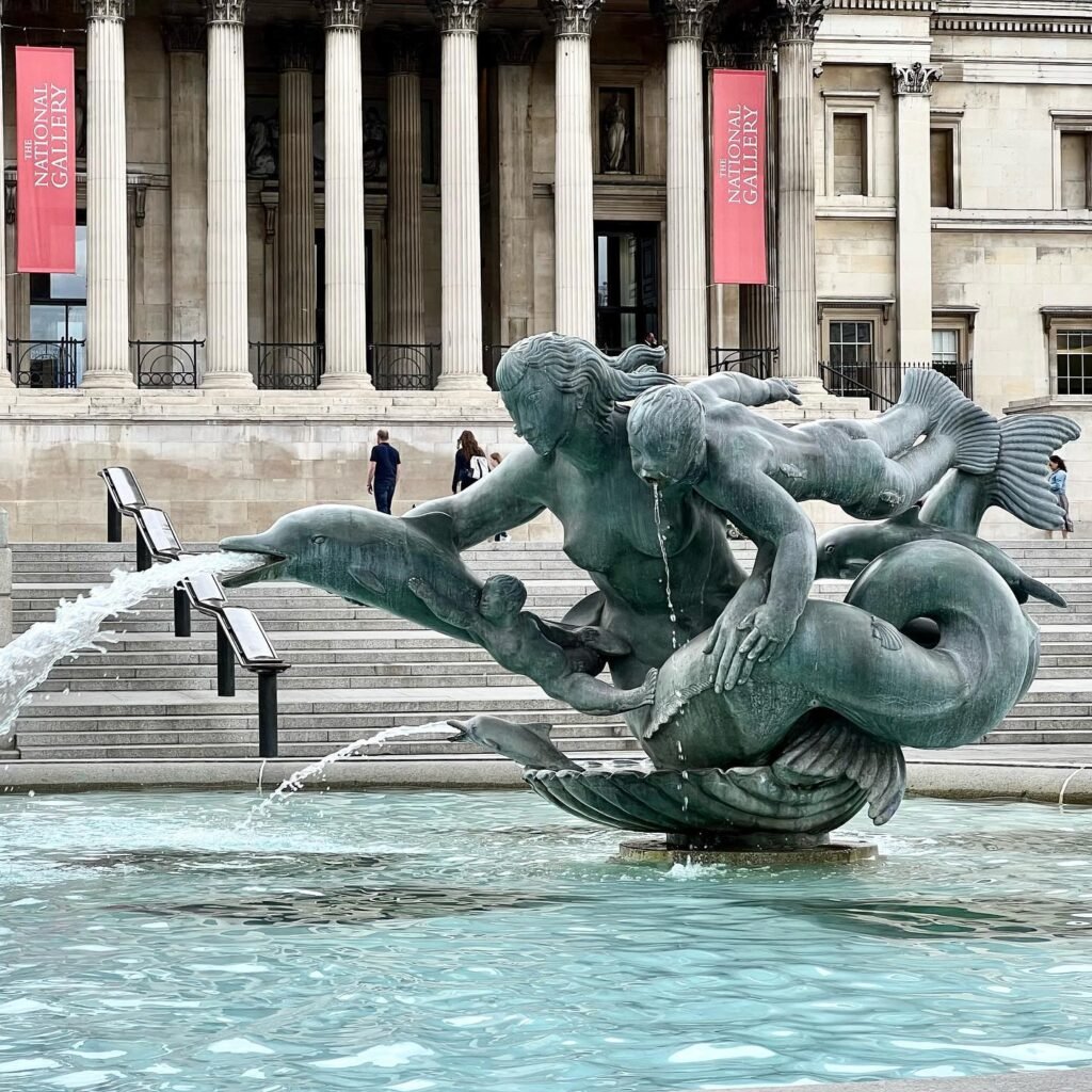A detailed view of the sculpted mermaid fountain at the Philadelphia Museum of Art with water flowing from the bronze figures.