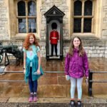 Superbloom Group and individual shots of travelers in front of Windsor Castle's historic stone architecture.