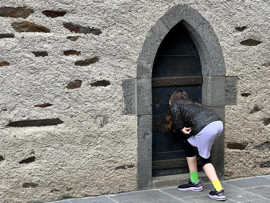 A playful moment at a historic stone archway on Giant's Causeway in Northern Ireland.