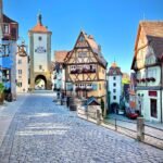 Feuchtwangen A scenic view of traditional European architecture featuring cobblestone streets and colorful half-timbered buildings.