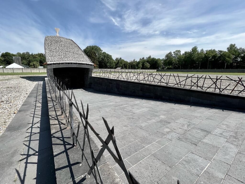 A view of Fort Vancouver's historic stockade and the new gatehouse under construction. The site features traditional stockade fencing and a modern-roofed structure.