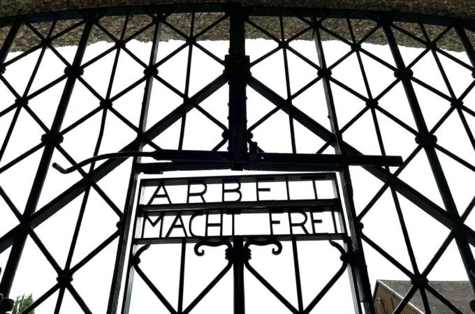 Intricate lattice pattern of a wrought iron gate with bold lettering. Architectural detail from a travel photo on JohnandKristie.