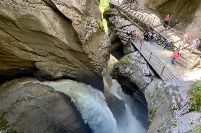 Panoramic view of Snoqualmie Falls and the surrounding rock gorge with a viewing platform.