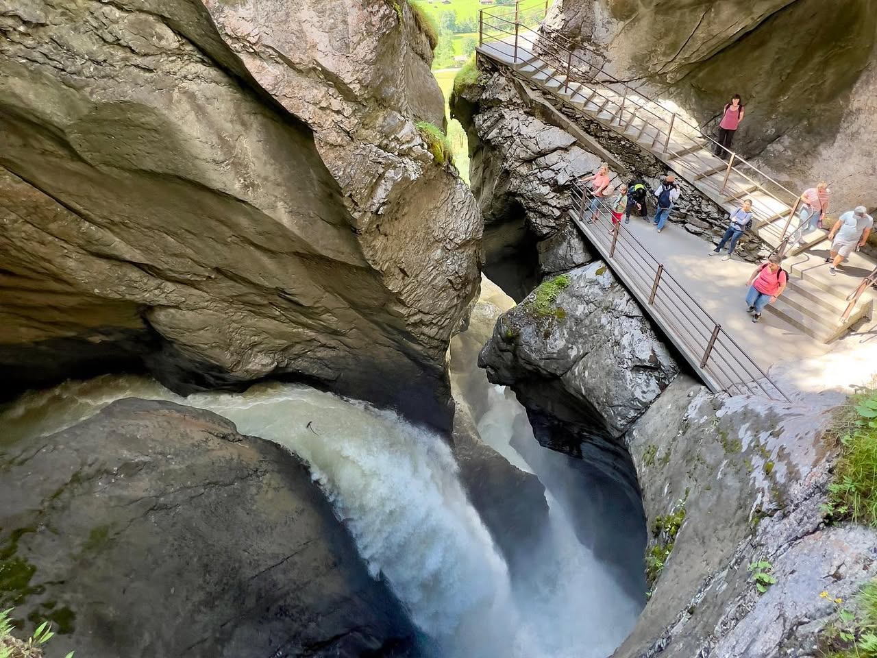 Panoramic view of Snoqualmie Falls and the surrounding rock gorge with a viewing platform.