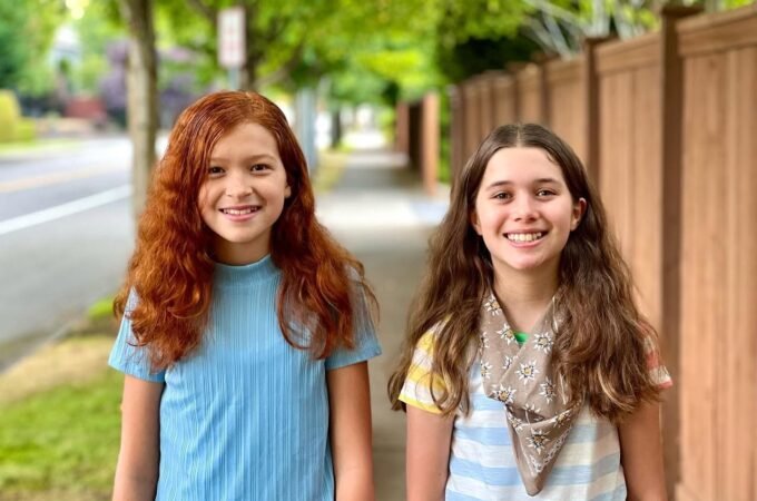 Two young individuals stand side by side on a tree-lined path, with close-up shots highlighting their smiles and casual outfits.
