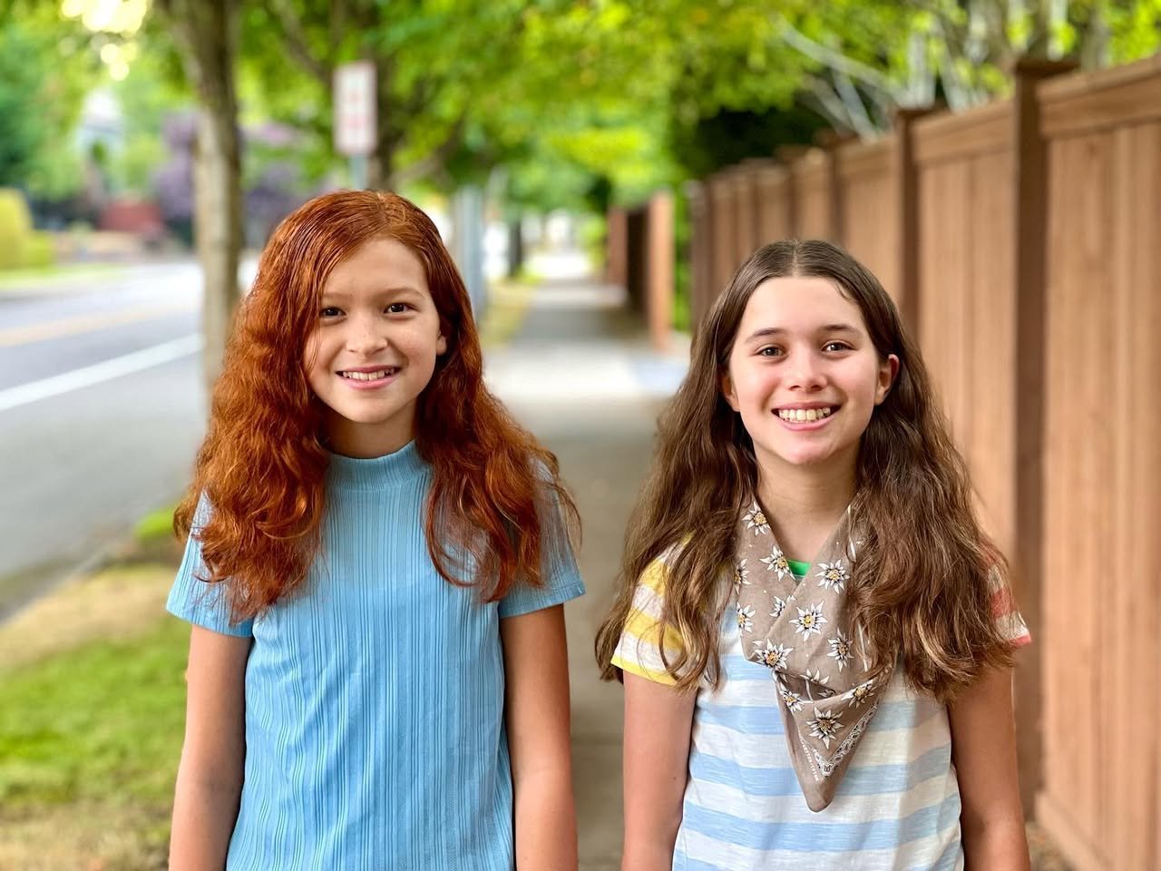 First Day of Middle School Two young individuals stand side by side on a tree-lined path, with close-up shots highlighting their smiles and casual outfits.