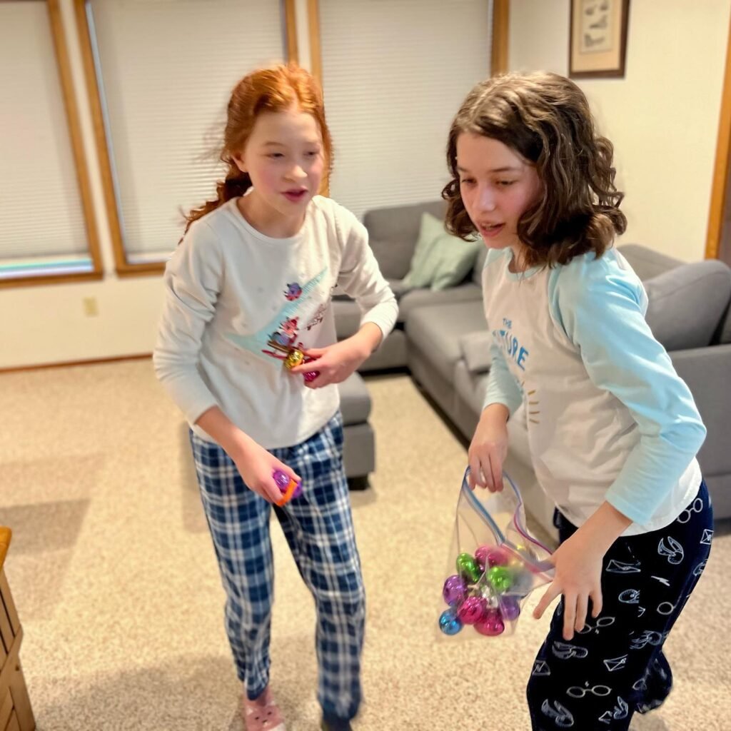 Two children playing with colorful toys in a cozy living room, capturing joyful everyday moments.