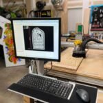 Mother’s Day Bike Ride CNC router in a workshop with a computer displaying the design being cut.