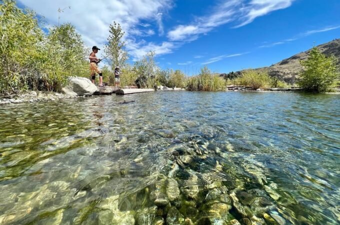 Panoramic collage of a clear river with rocky banks, bright blue skies, and green foliage under sunny conditions.
