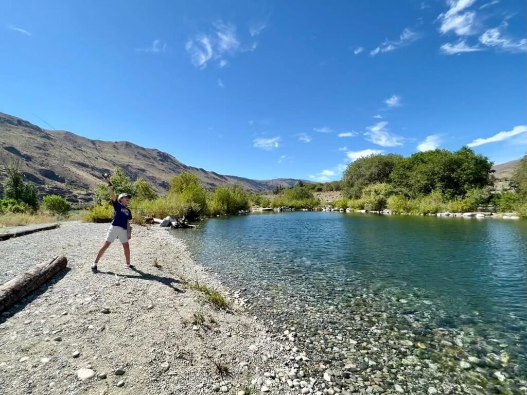 A collage of scenic shots featuring a clear river, rocky banks, and a person walking. The landscape is framed by dry hillsides and a bright blue sky.