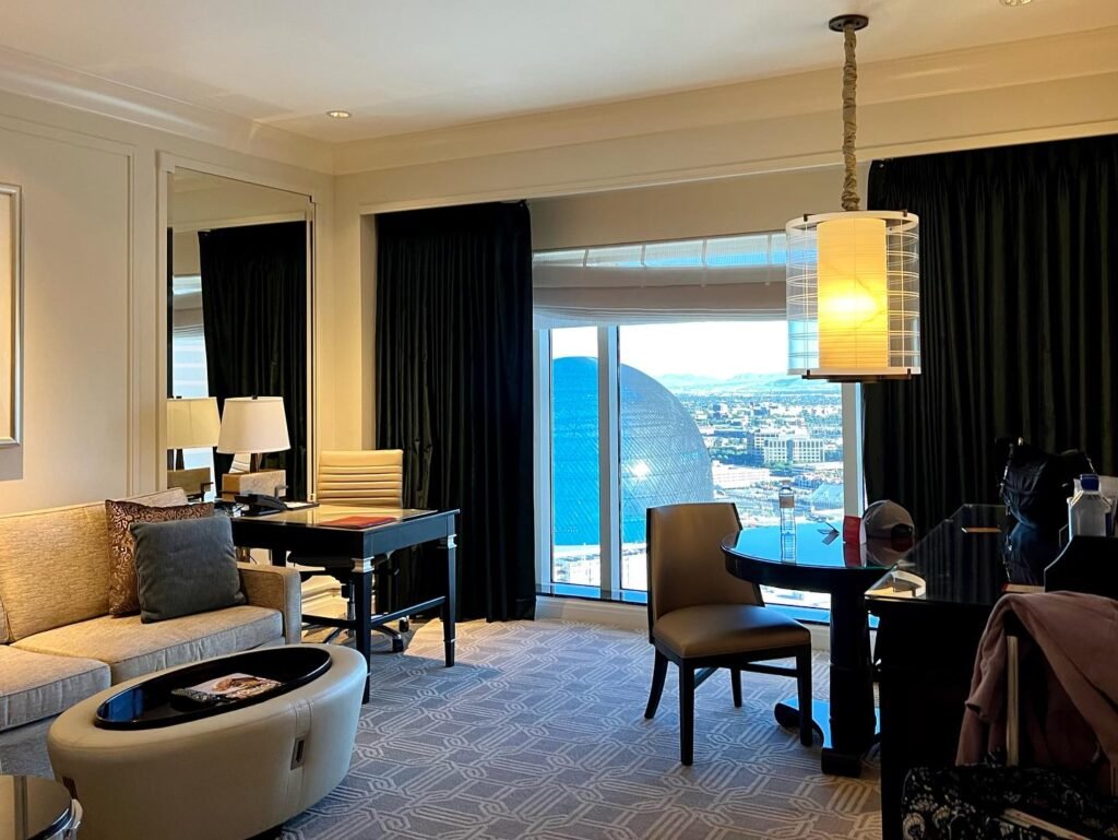 Elegant hotel suite with a view of a marina.