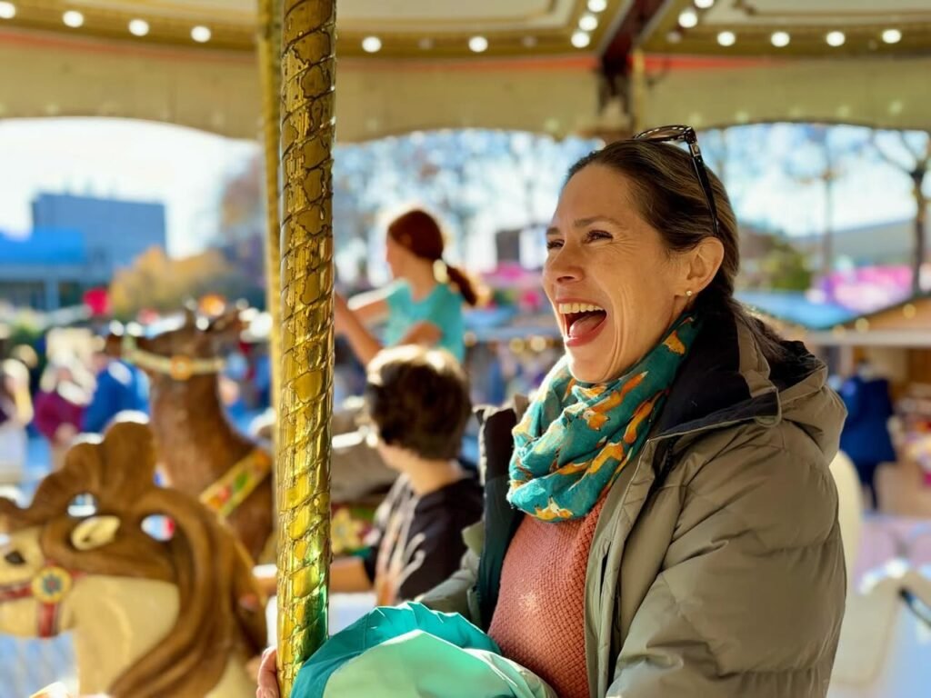 A person laughing while riding a carousel at a fair, capturing a moment of joy.