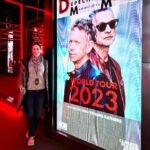 Seattle Christmas Market A person visits the Expo 2023 venue, shown alongside a close-up of a Depeche Mode 2023 World Tour poster.