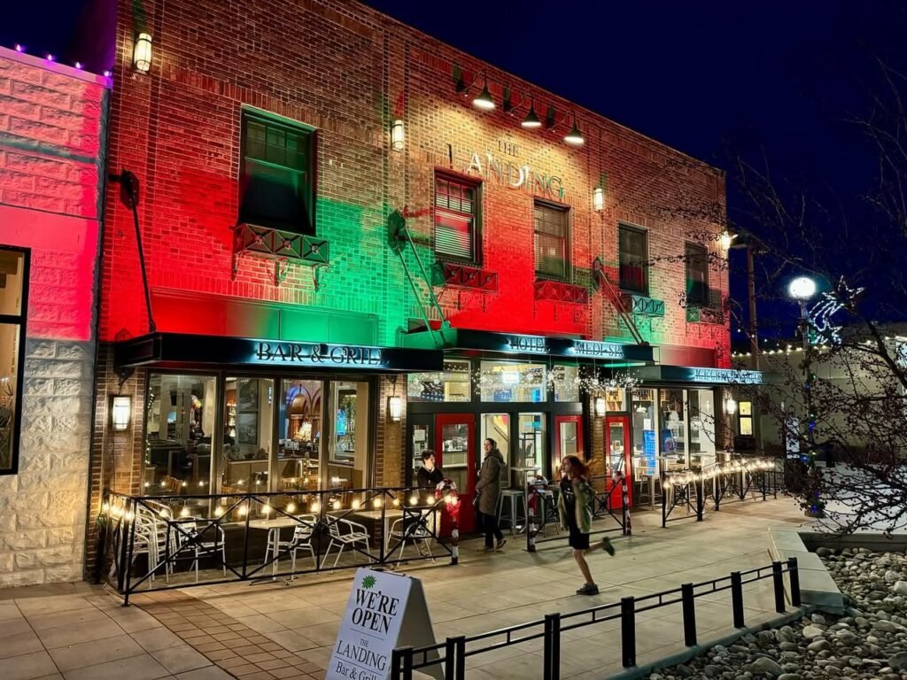 Vine & Cask restaurant in Santa Barbara illuminated with red, white, and green lights at night. A sidewalk and brick facade are visible.