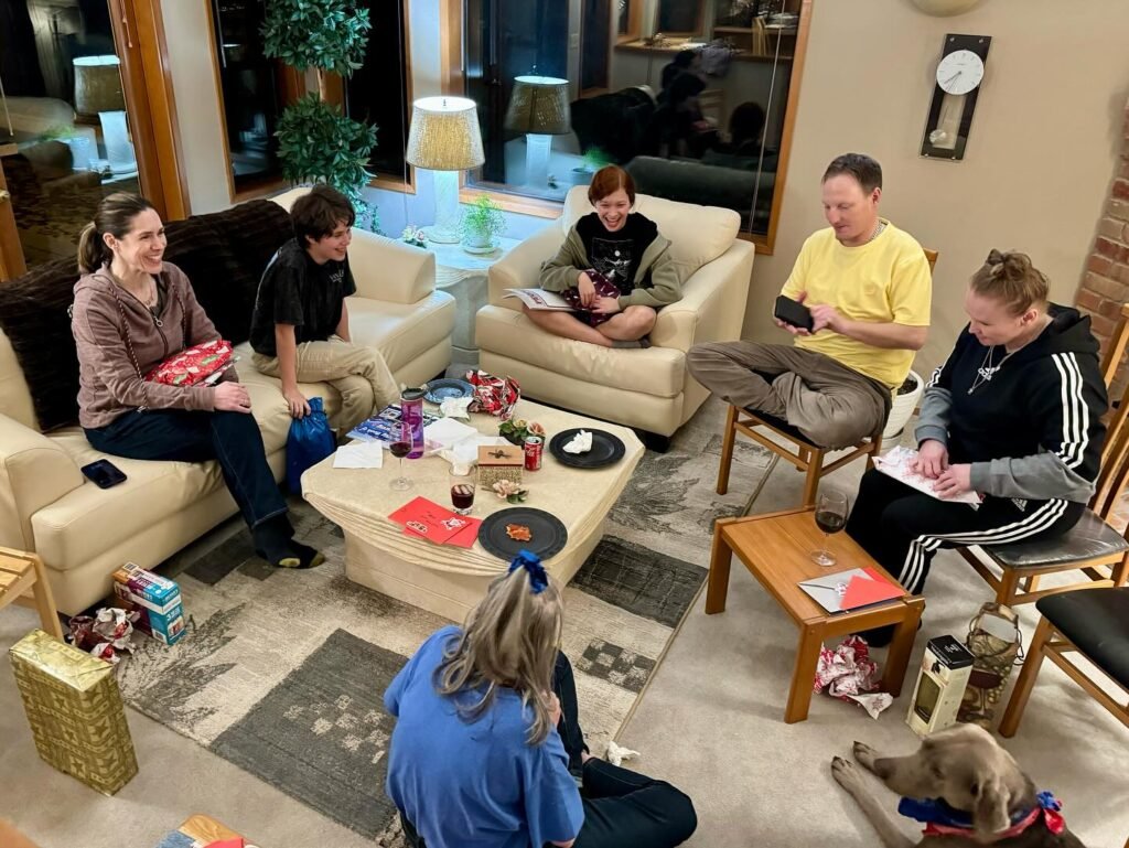 A family playing board games in a cozy living room relaxation. Family game night with friends and a dog.