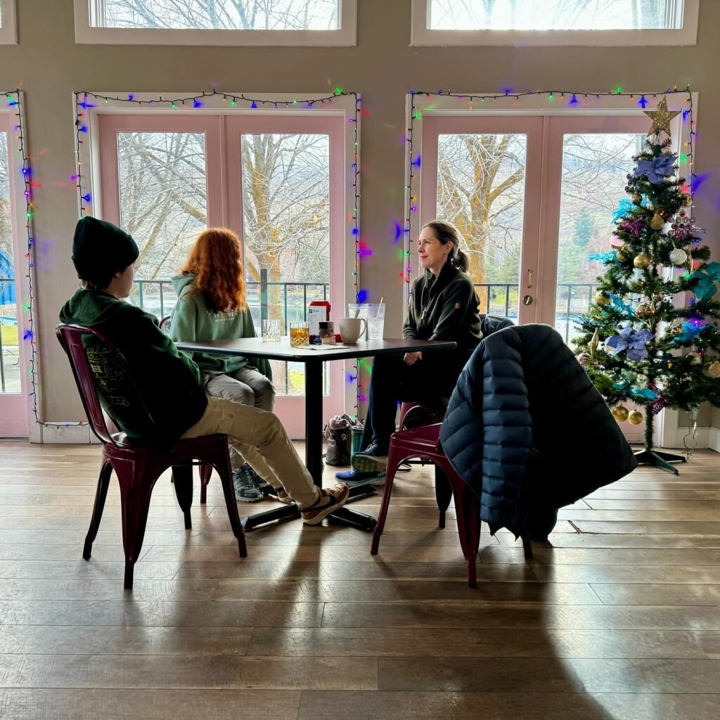 Festive Café Gathering by the Christmas Tree