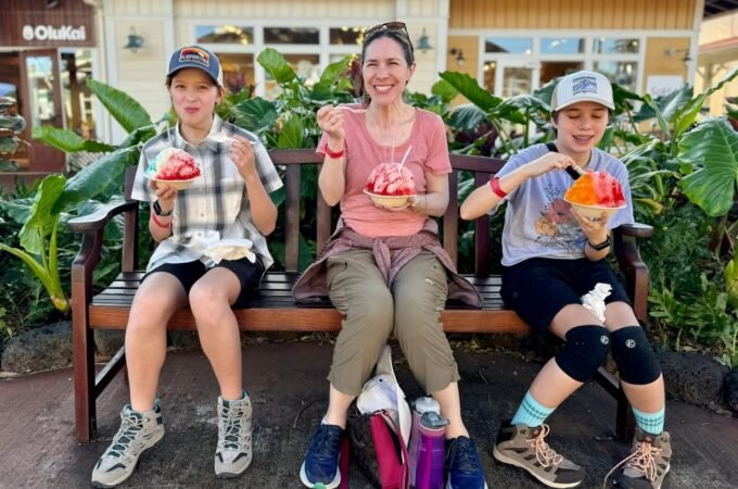 A family enjoys shaved ice at a Hilo, Hawaii cafe. The group shares colorful treats in a tropical setting.